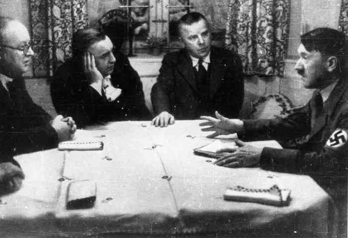 Adolf Hitler meets party publishers Max Amann and Adolf Müller and treasurer Franz Xaver Schwarz in Amann's house in St. Quirin